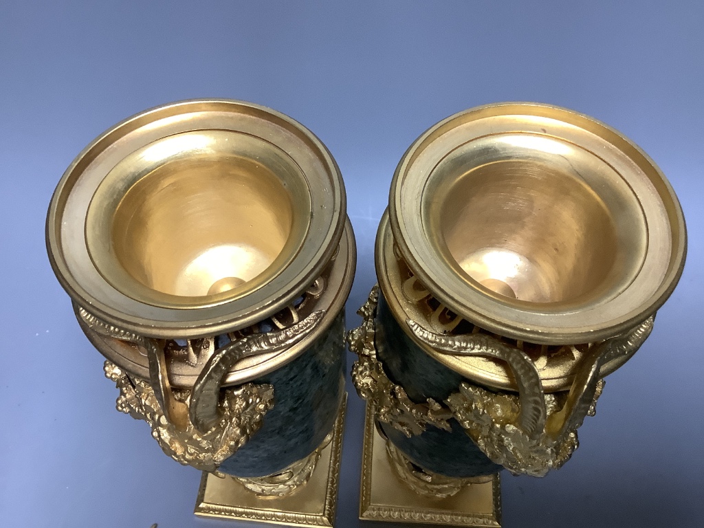 A modern pair of gilt metal and marble urns 32cm